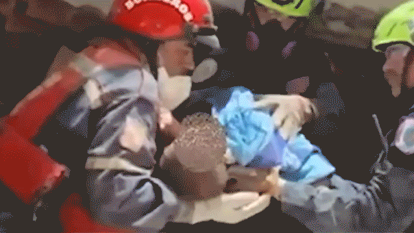 Gif of an infant trapped beneath the rubble being rescued